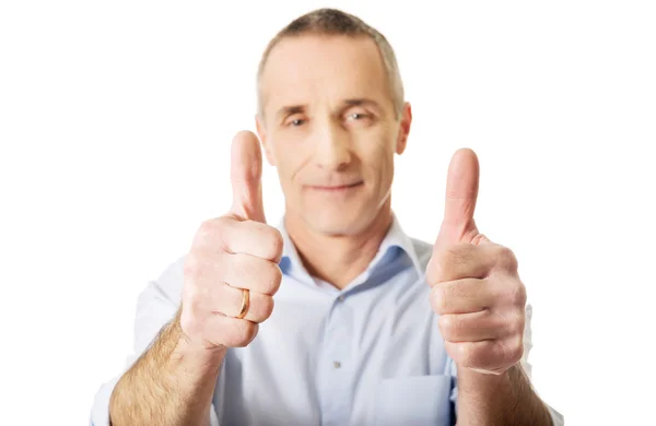 Mature man gesturing thumbs up sign — Stock Photo, Image