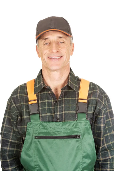 Mature gardener standing in uniform — Stock Photo, Image