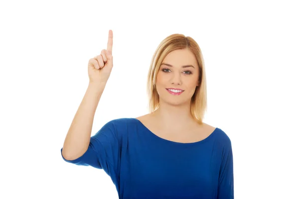 Young woman pointing up. — Stock Photo, Image