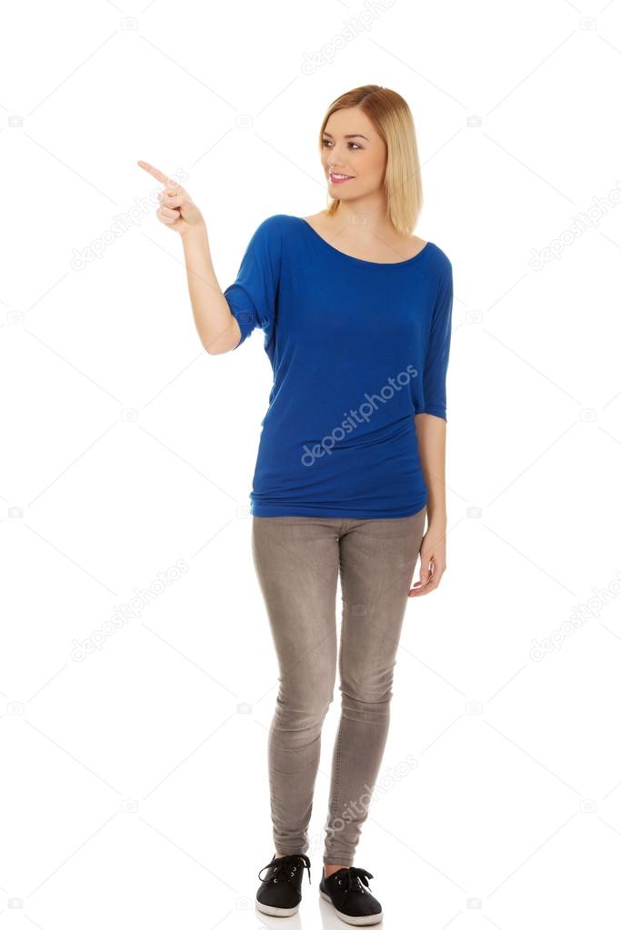 Young woman pointing up.