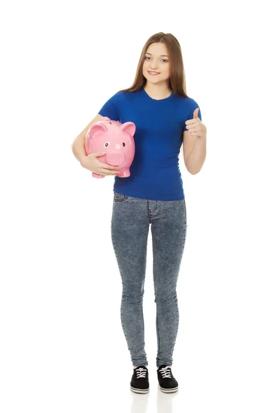 Teenage woman holding piggybank. — Stock Photo, Image