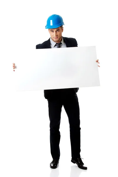 Businessman enginner holding empty banner. — Stock Photo, Image