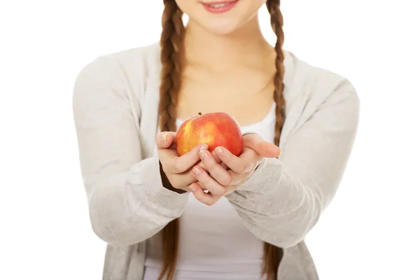 Teenage woman holding an apple. — Stock Photo, Image