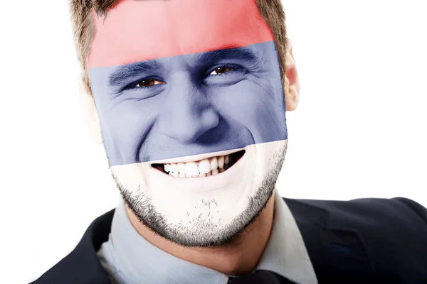 Happy man with Serbia flag on face. — Stock Photo, Image