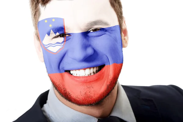 Glücklicher Mann mit Slowenien-Fahne im Gesicht. — Stockfoto