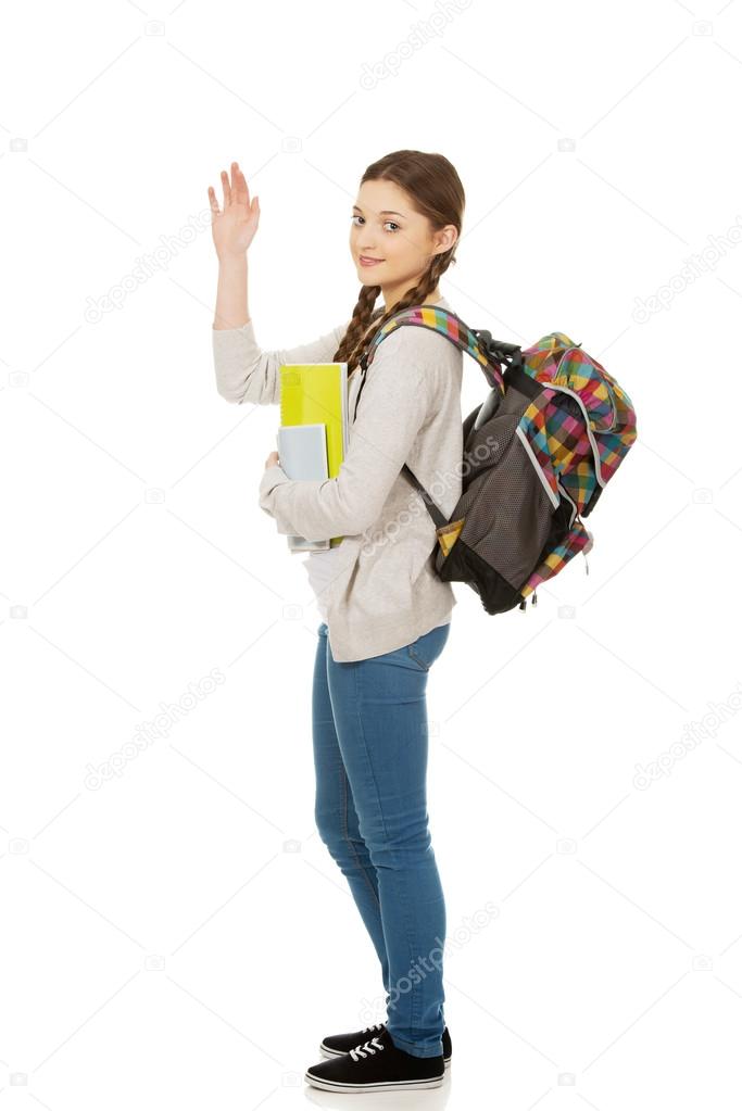 Schoolgirl waving her hand.