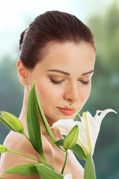 Woman with a lily flower. — Stock Photo, Image