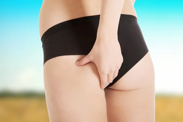 Woman checking fat on buttocks. — Stock Photo, Image