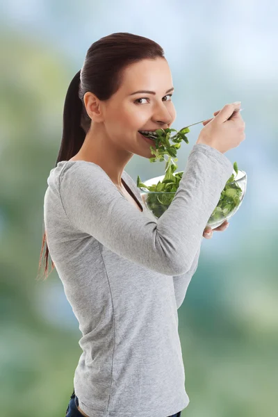 Woman eating lambs lettuce. — Stock Photo, Image