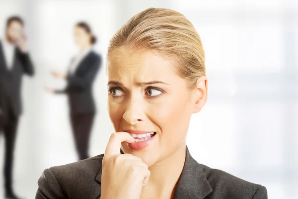 Businesswoman biting her nails. — Stock Photo, Image