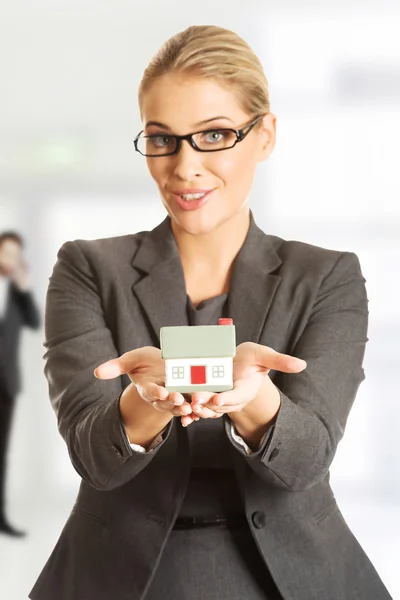 Businesswoman with house model. — Stock Photo, Image