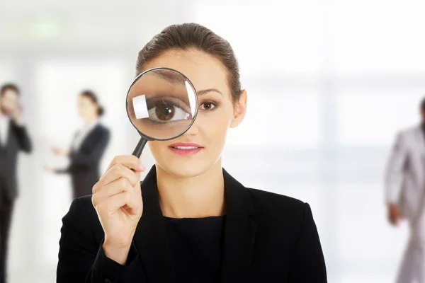 Businesswoman with magnifier glass. — Stock Photo, Image