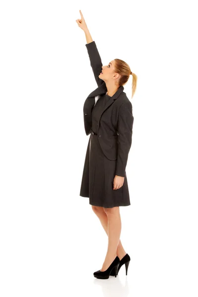 Businesswoman pointing up. Stock Photo