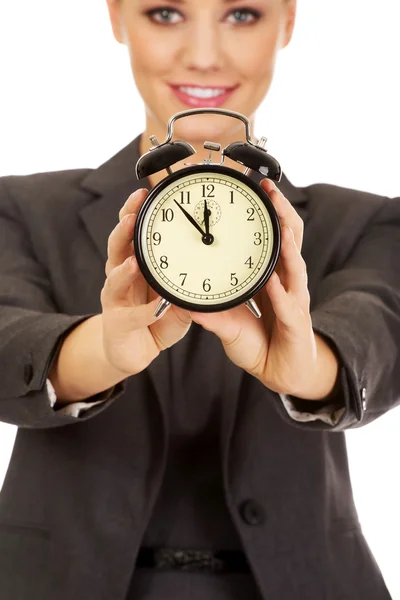 Young businesswoman with a clock. Stock Photo