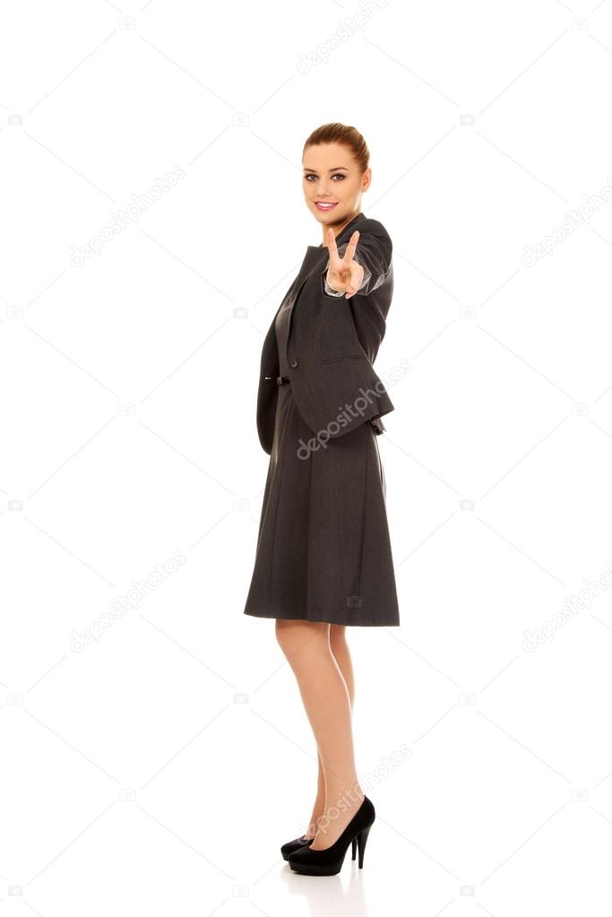 Business woman showing victory sign.