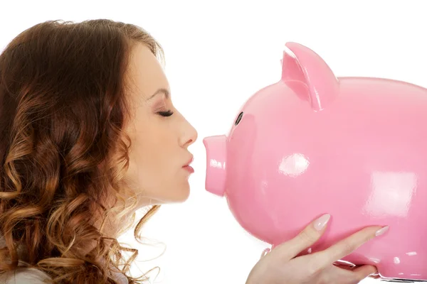 Business woman kissing a piggybank. — Stock Photo, Image