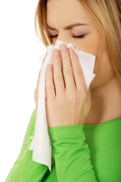Woman sneezing to tissue. — Stock Photo, Image