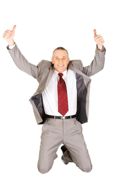 Excited businessman jumping with ok sign — Stock Photo, Image