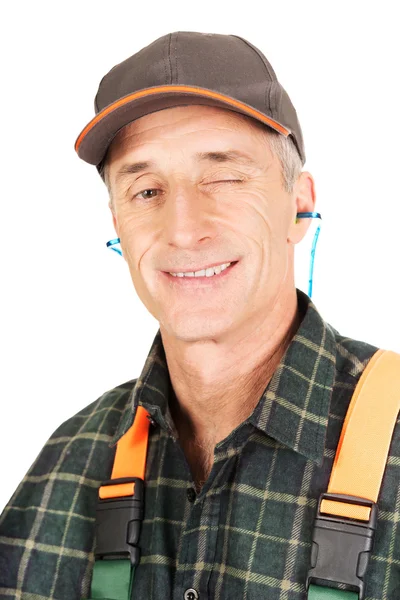 Mature worker blinks his eye — Stock Photo, Image