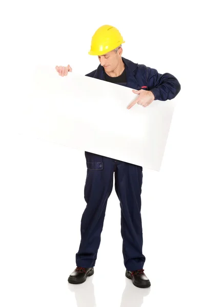 Happy worker presenting empty banner — Stock Photo, Image