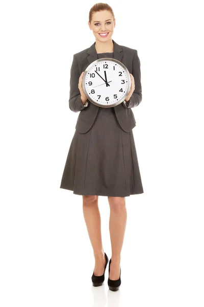 Young businesswoman with a clock. — Stock Photo, Image