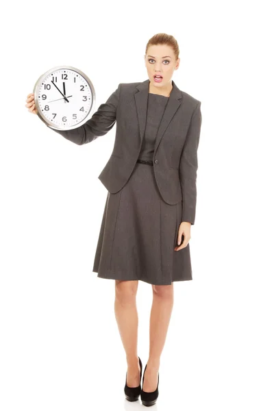 Shocked businesswoman with a clock. Royalty Free Stock Images