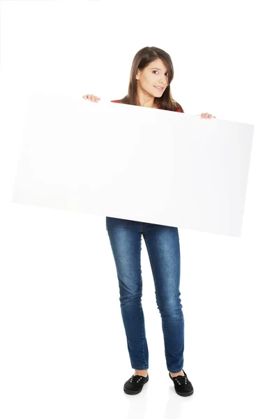 Happy woman holding empty banner. — Stock Photo, Image