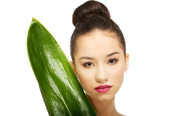 Beautiful woman with green leaf. — Stock Photo, Image