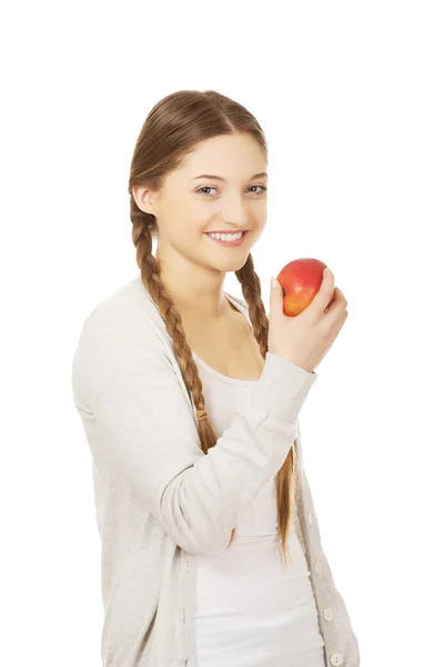 Teenage woman holding an apple. — Stock Photo, Image