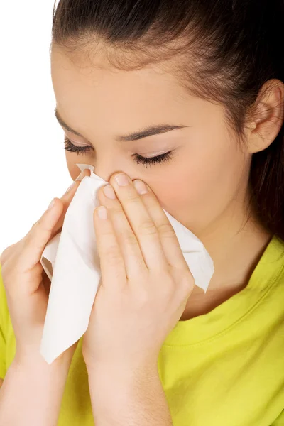 Teen woman sneezing to tissue. — Stock Photo, Image