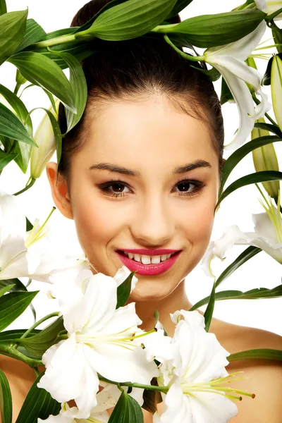 Beauty face of a woman with flowers. — Stock Photo, Image