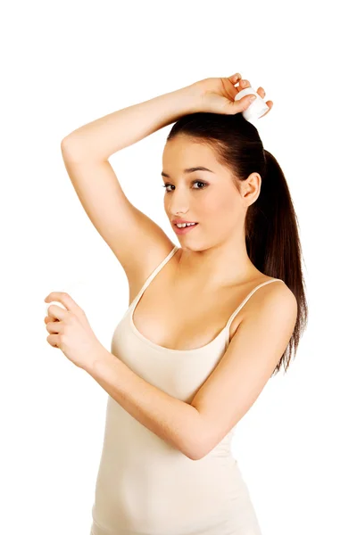 Young woman applying anti perspirant. — Stock Photo, Image