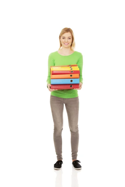 Young woman with heavy binders. — Stock Photo, Image
