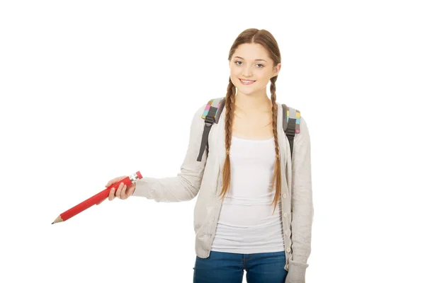 Colegiala apuntando hacia abajo con lápiz . —  Fotos de Stock