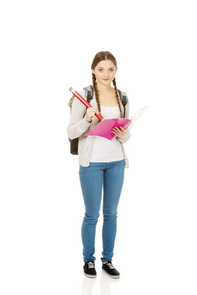 Teen woman writing with huge pencil. — Stock Photo, Image