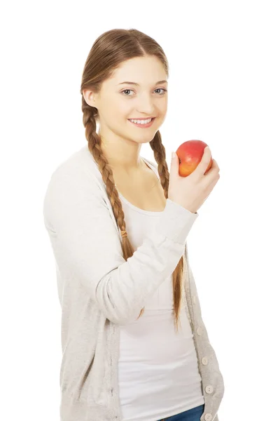 Teenage woman holding an apple. — Stock Photo, Image