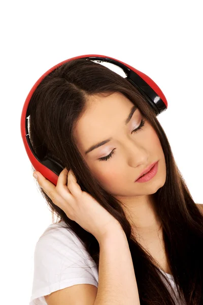 Rock woman with headphones listening to music. — Stock Photo, Image