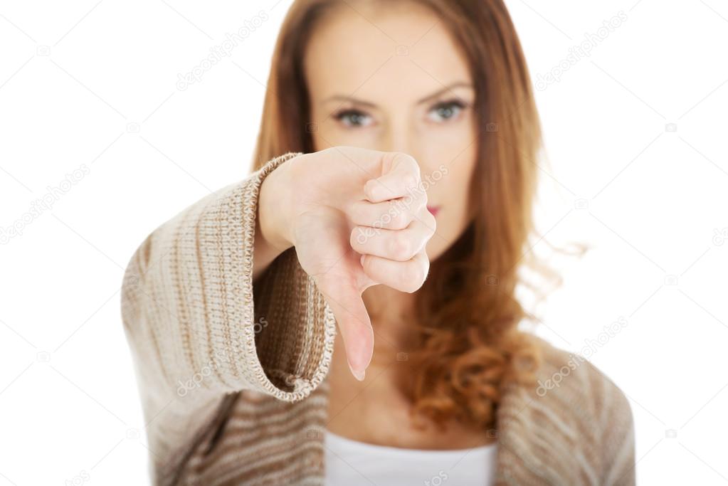 Unhappy woman with thumbs up.