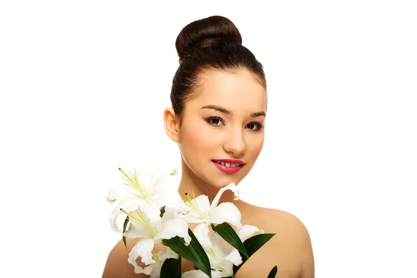 Beauty face of a woman with flower. — Stock Photo, Image