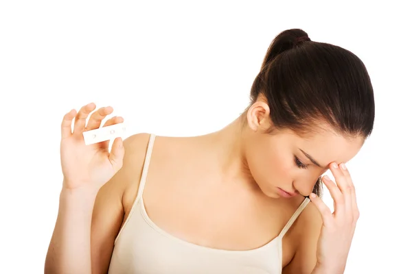 Depressed woman with pregnancy test. — Stock Photo, Image