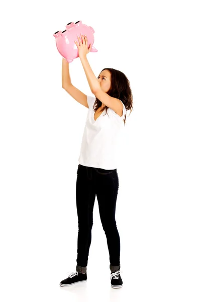 African woman shaking piggybank. — Stock Photo, Image