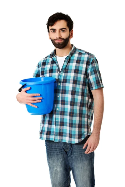 Handsome man holding plastic bucket. — Stock Photo, Image