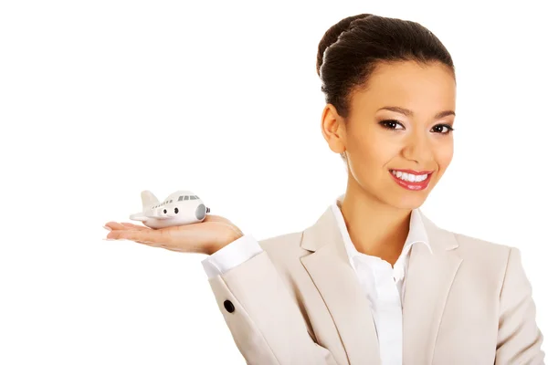 Businesswoman holding small plane on palm. — Stock Photo, Image