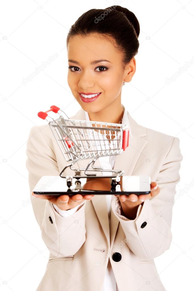 Businesswoman with shopping cart and tablet.