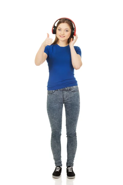 Woman with headphones and thumbs up. — Stock Photo, Image