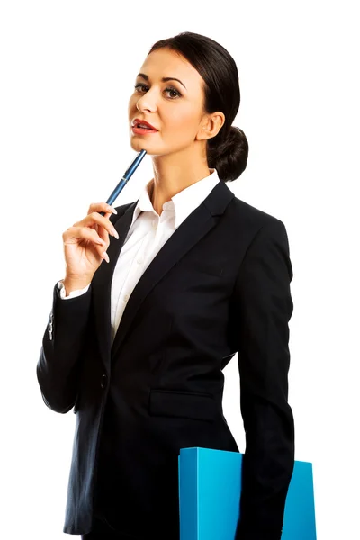 Thoughtful businesswoman holding a pen — Stock Photo, Image