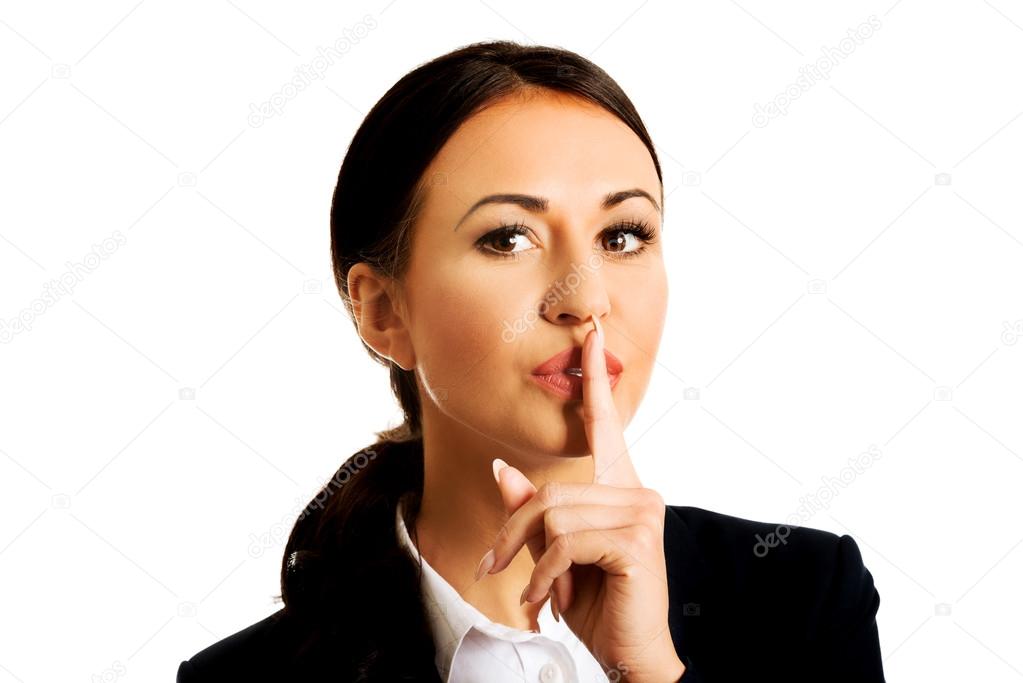 Businesswoman making silent sign