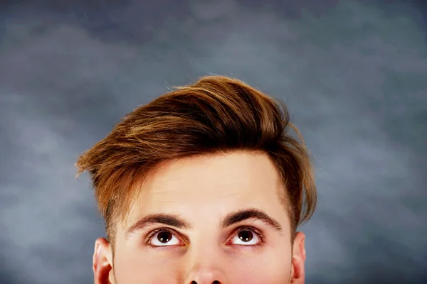 Handsome man with brown eyes looking up. — Stock Photo, Image