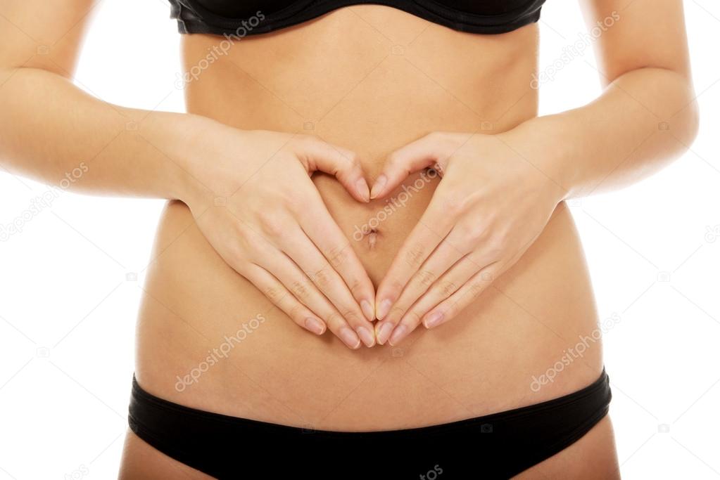 Woman with hands on belly.