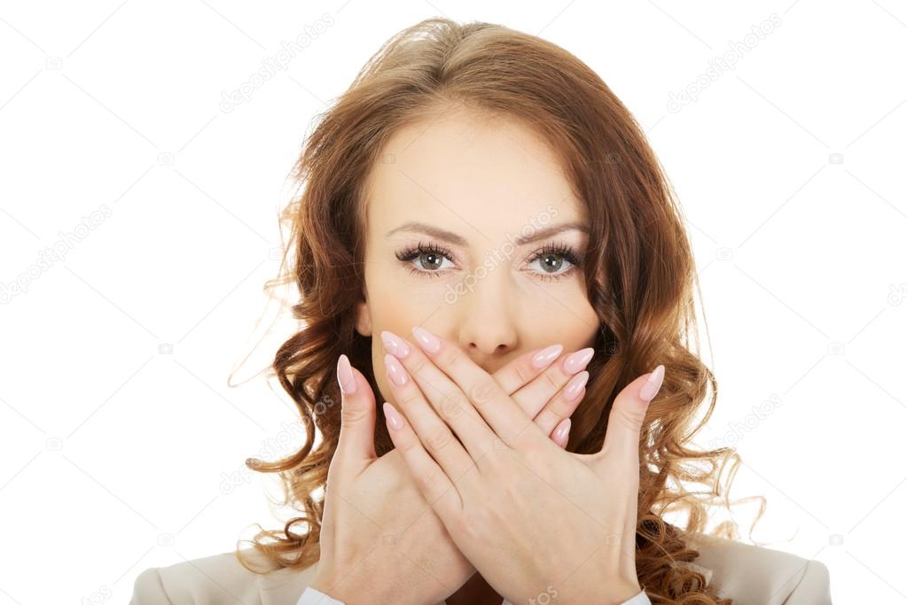 Businessman covering mouth by hand.